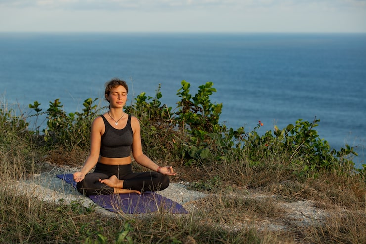 Persona meditando en la naturaleza